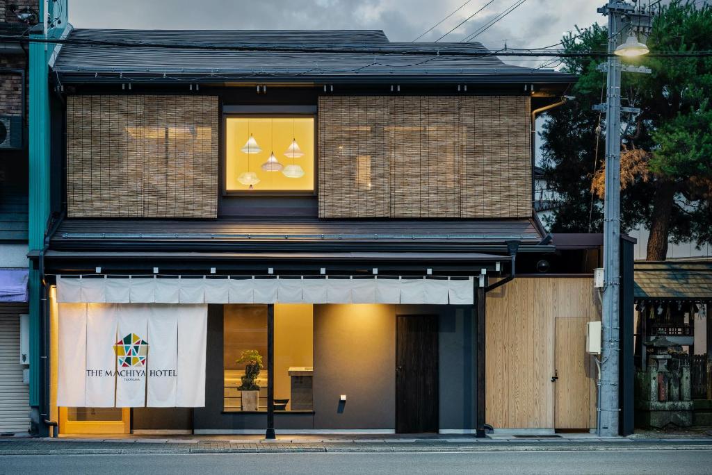 a store front with a sign in the window at THE MACHIYA HOTEL TAKAYAMA in Takayama