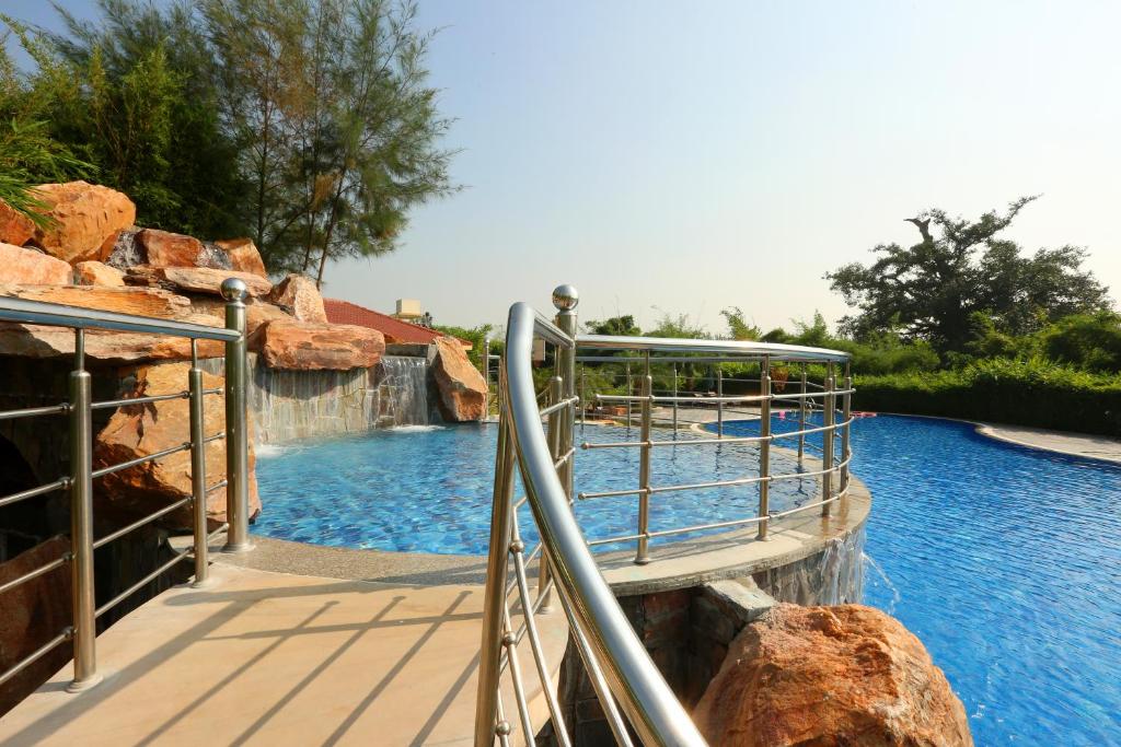 a water slide in a pool at a resort at Resort De Coracao - Corbett , Uttarakhand in Rāmnagar