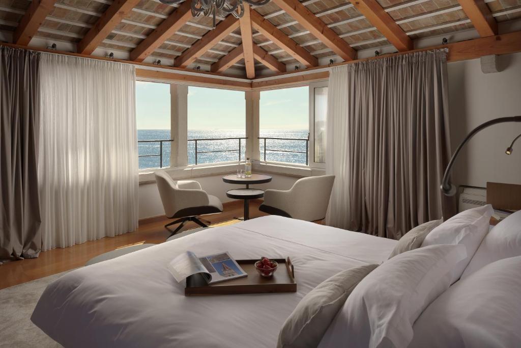 a bedroom with a bed with a view of the ocean at Malipiero Residence in Rovinj
