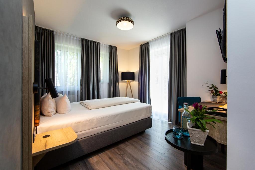 Postel nebo postele na pokoji v ubytování Arcus Hotel München Messe