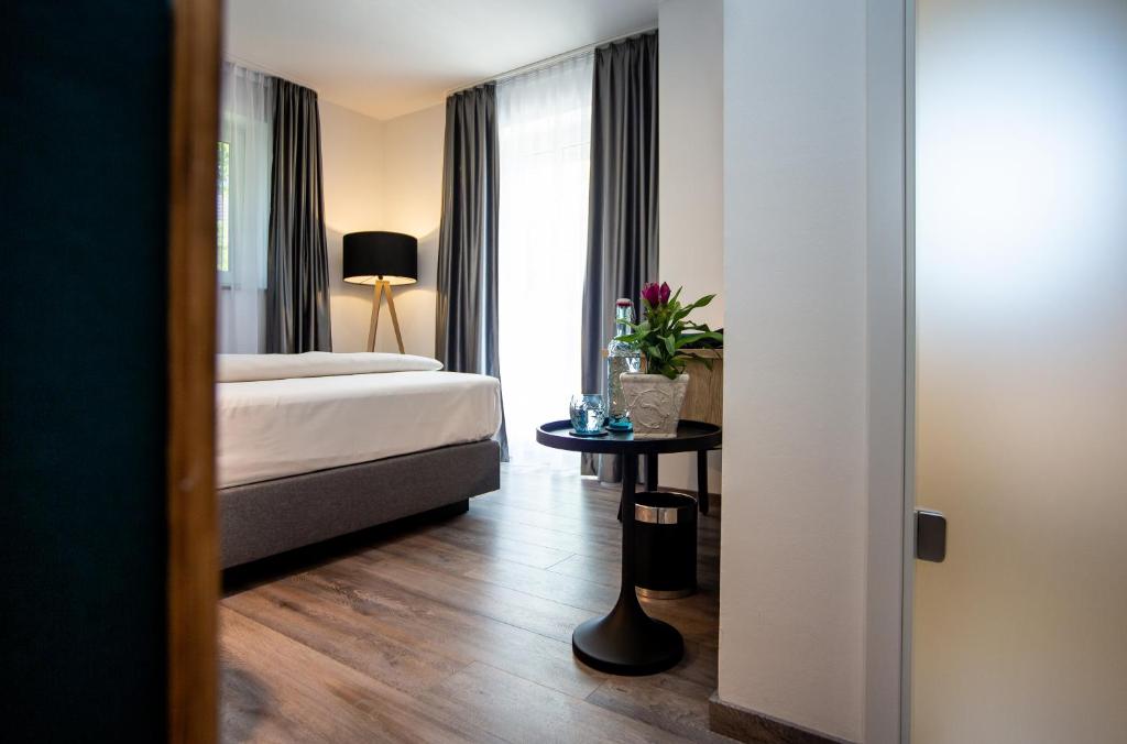 Postel nebo postele na pokoji v ubytování Arcus Hotel München Messe