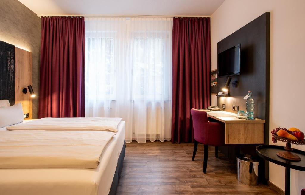 Postel nebo postele na pokoji v ubytování Arcus Hotel München Messe