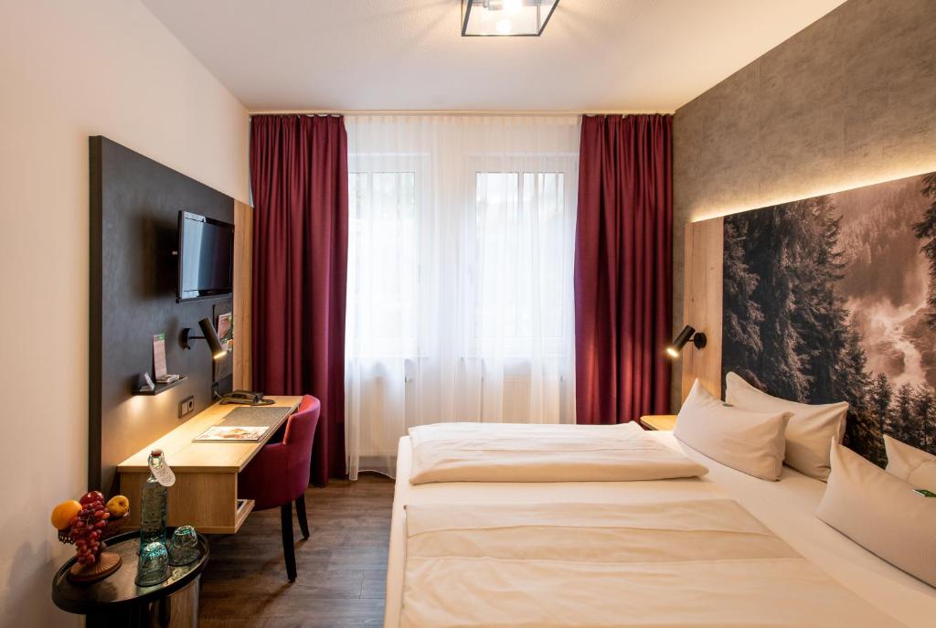 Postel nebo postele na pokoji v ubytování Arcus Hotel München Messe