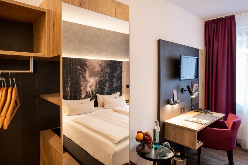 Postel nebo postele na pokoji v ubytování Arcus Hotel München Messe