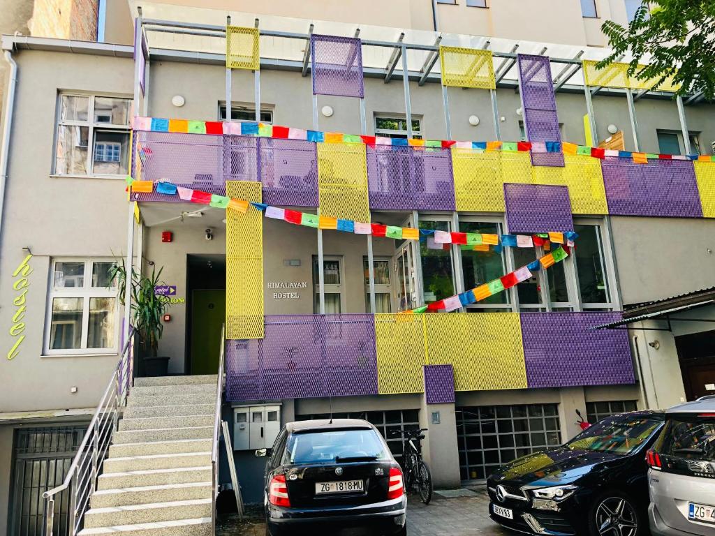 a building with a colorful banner in front of it at Himalayan Hostel in Zagreb