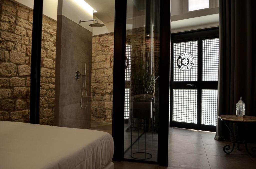 a bedroom with a bed and a walk in shower at Covo del Carbonaro in Ascoli Piceno