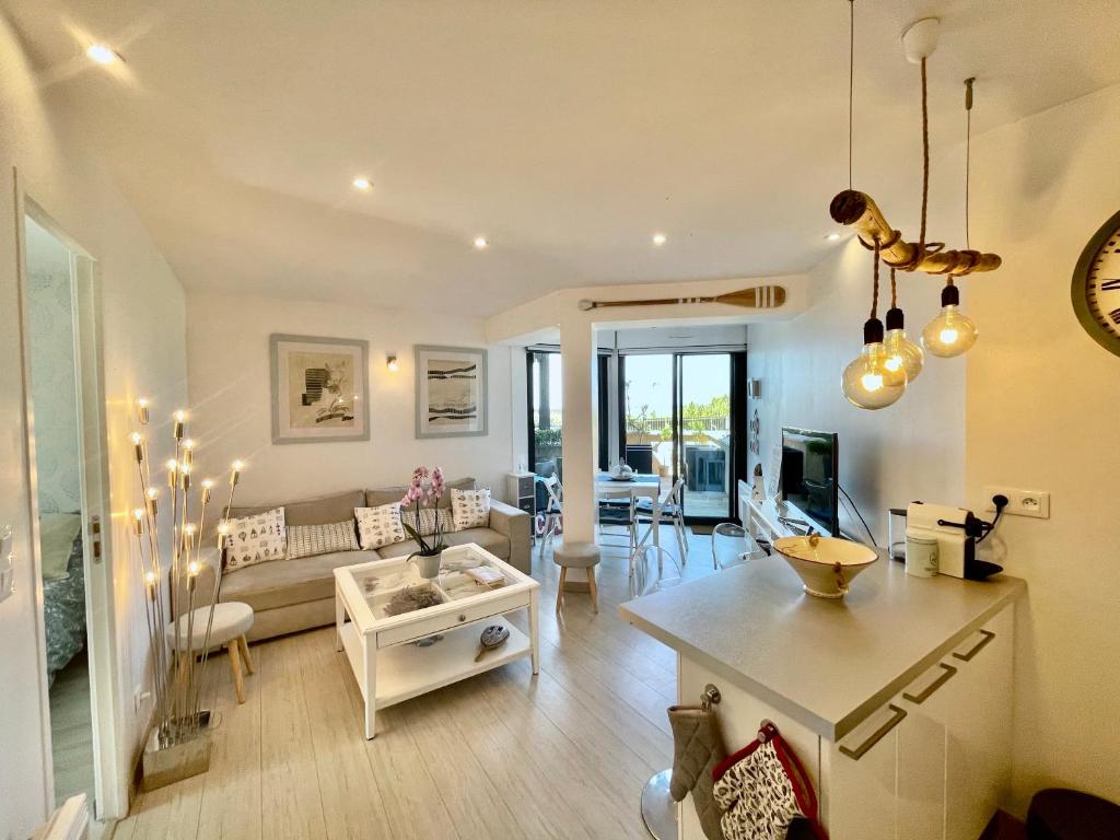 a living room with a couch and a table at On the Beach in Lacanau-Océan