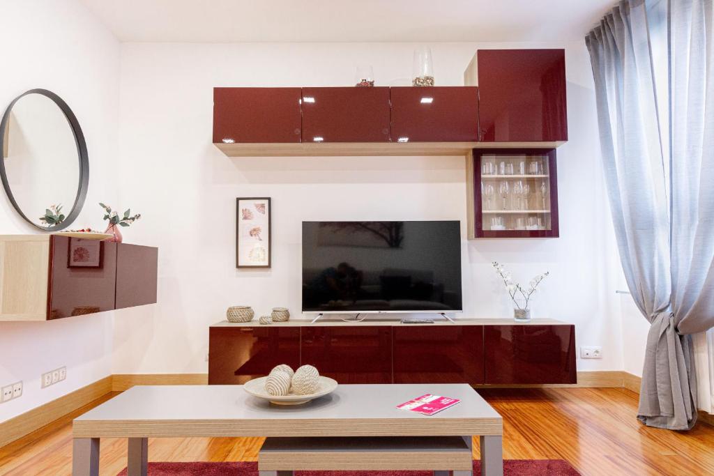 a living room with a tv and a coffee table at Dolaretxe apartment by People Rentals in Bilbao