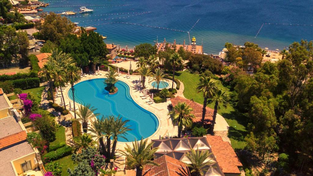 an aerial view of a resort with a swimming pool at Divan Bodrum Palmira in Golturkbuku