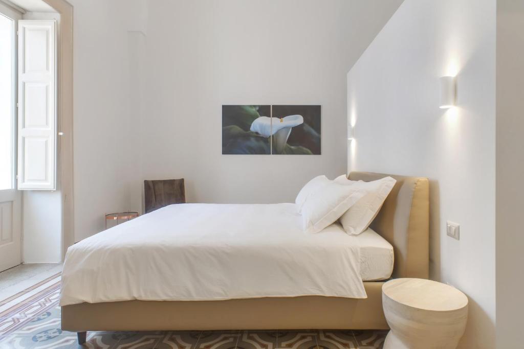 A bed or beds in a room at PALAZZO FRANGIPANE