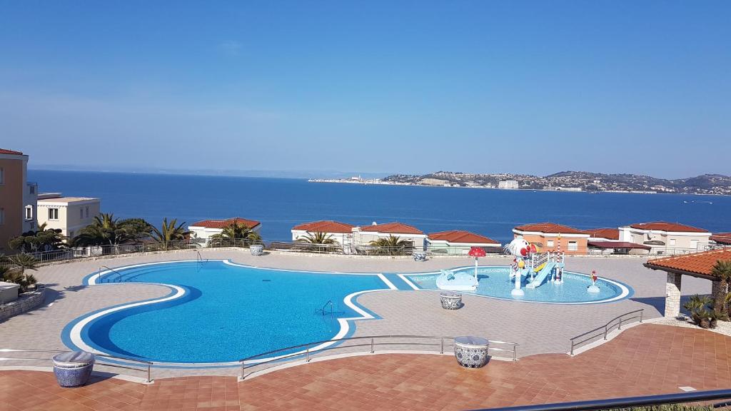 a swimming pool with the ocean in the background at Skiper Resort Savudrija - Umag - LGP in Savudrija
