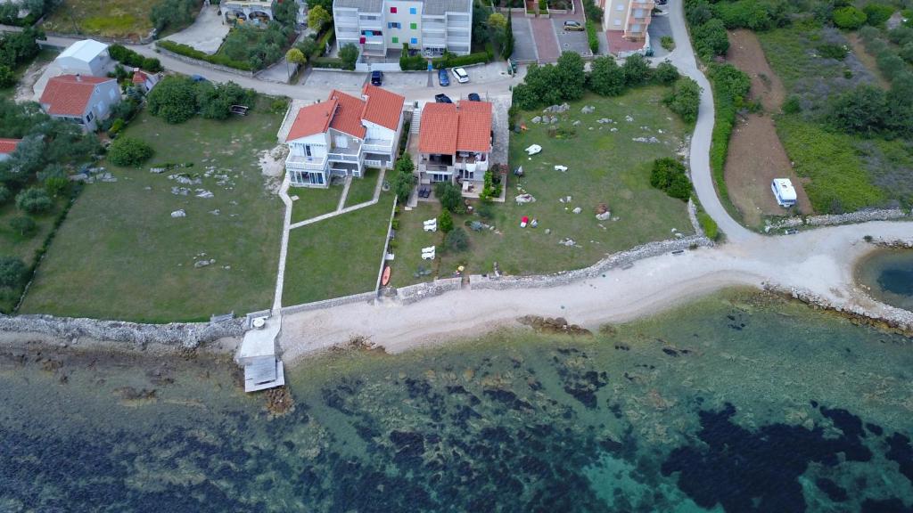 an aerial view of a house on an island in the water at Apartman Ema Dobropoljana in Dobropoljana