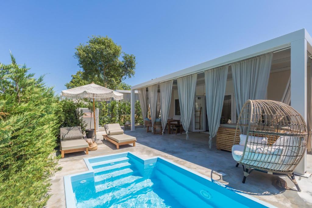 a house with a bird cage on a patio at Polidor Camping Resort in Poreč