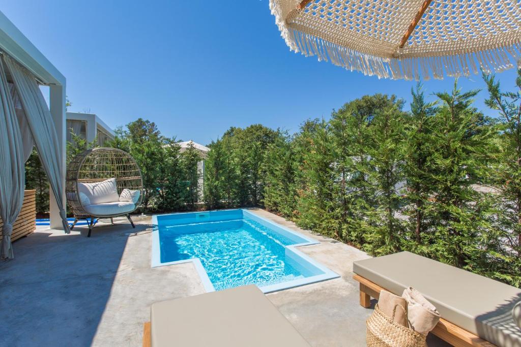 a backyard with a swimming pool and a chair at Polidor Camping Resort in Poreč