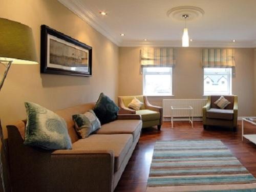 a living room with a couch and a chair at Luxurious KC House in Dungannon