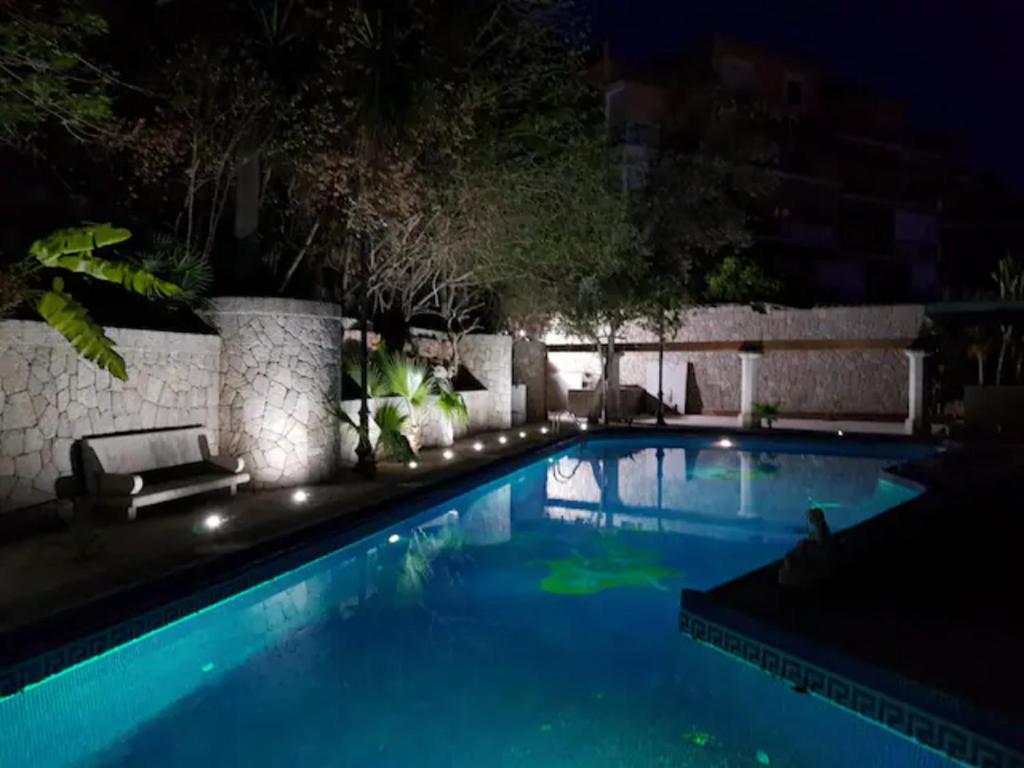 a large swimming pool at night at Palma Ambassador Center ETV14825 in Palma de Mallorca