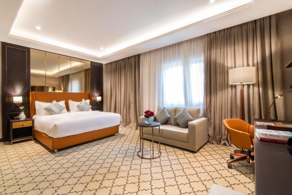 a large hotel room with a bed and a couch at Gardino Hotel & Residence in Riyadh