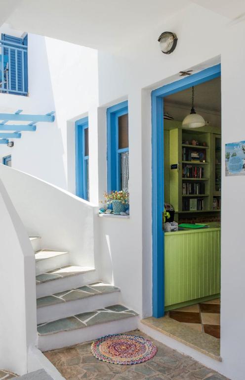 a staircase in a house with a blue door at Saronis Hotel Agistri - Adults Only in Skala