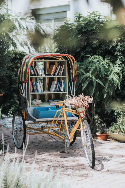 a bike with a book cart with books on it at Saronis Hotel Agistri - Adults Only in Skala