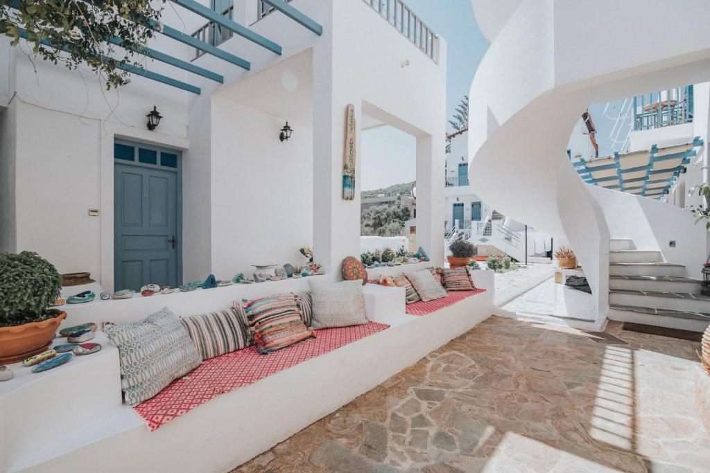 a living room with a long couch on a patio at Saronis Hotel Agistri - Adults Only in Skala