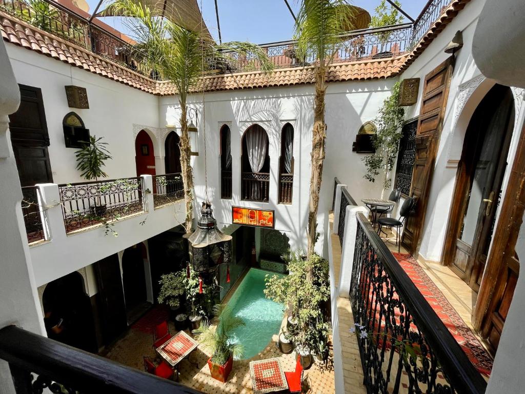 a room with a staircase leading up to a balcony at Riad La Porte Rouge in Marrakesh