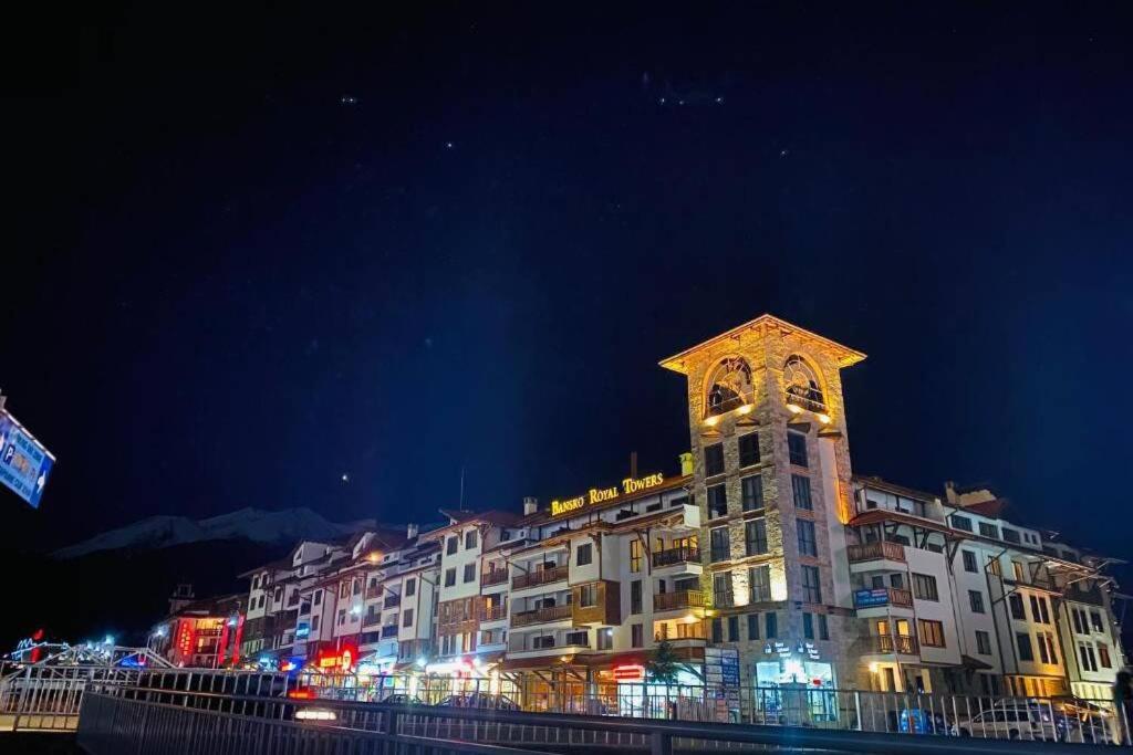 a large building with a clock tower at night at Bansko Royal Towers - Studio 1237 in Bansko