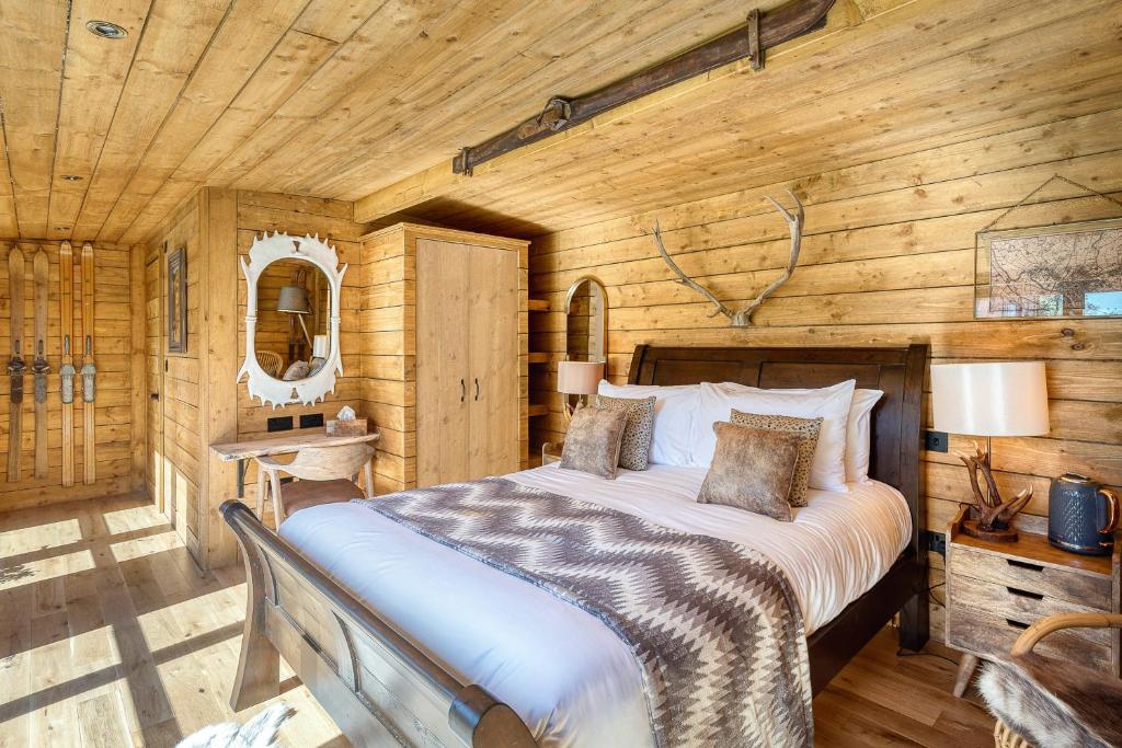 a bedroom with a bed in a wooden room at Clementine's Town House Hotel in York