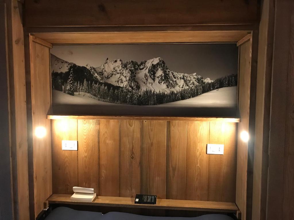 a picture of a snow covered mountain on a wall at Piccolo paradiso in centro Cervinia in Breuil-Cervinia