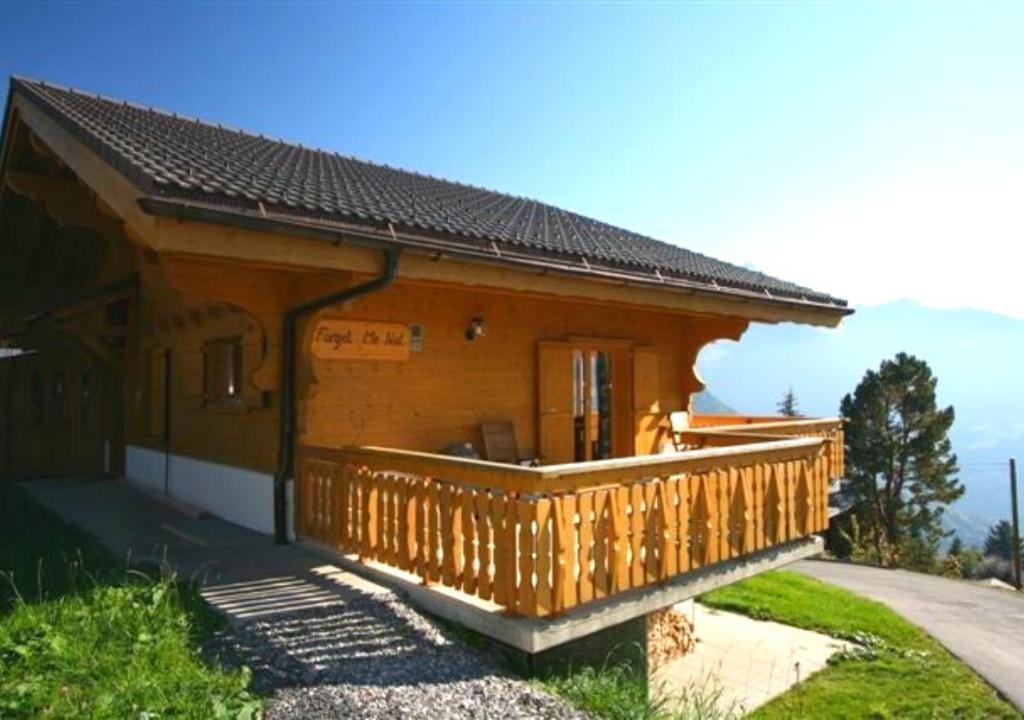 a small wooden house with a large wooden deck at Chalet Forget me not in Gryon