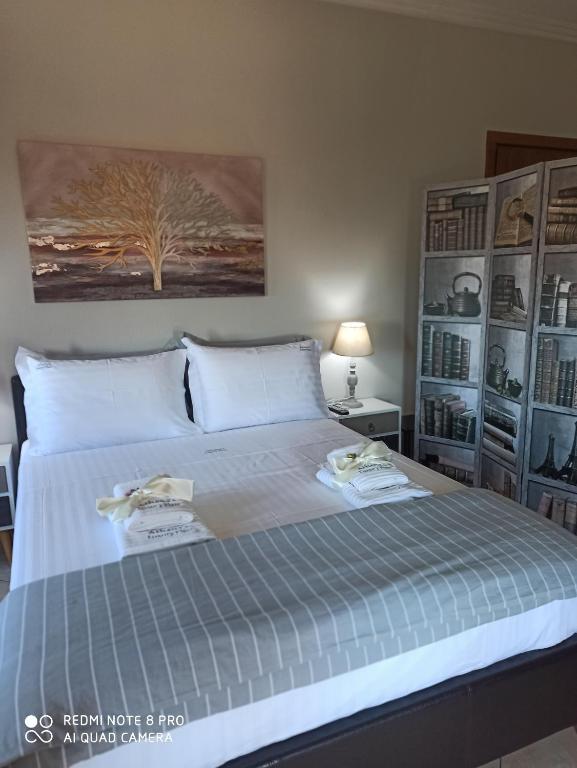 a bedroom with a bed with two towels on it at Athena's Luxury Place in Agria