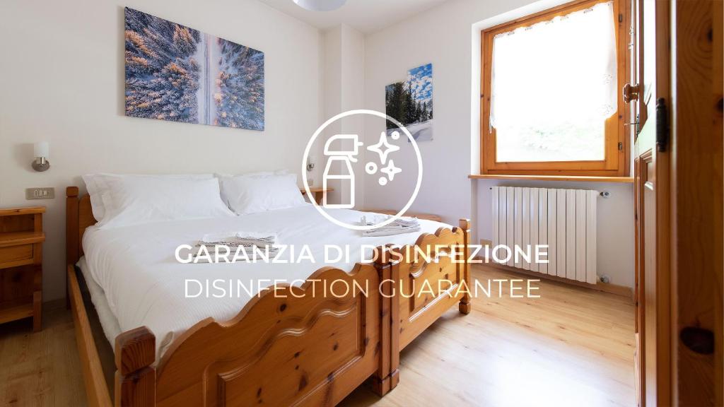 a bedroom with a bed and a window at Italianway - Belvedere 28 - Genziana in Valdidentro