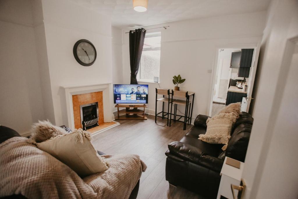 a living room with a couch and a tv at LIME St by Prestige Properties SA in Barrow in Furness