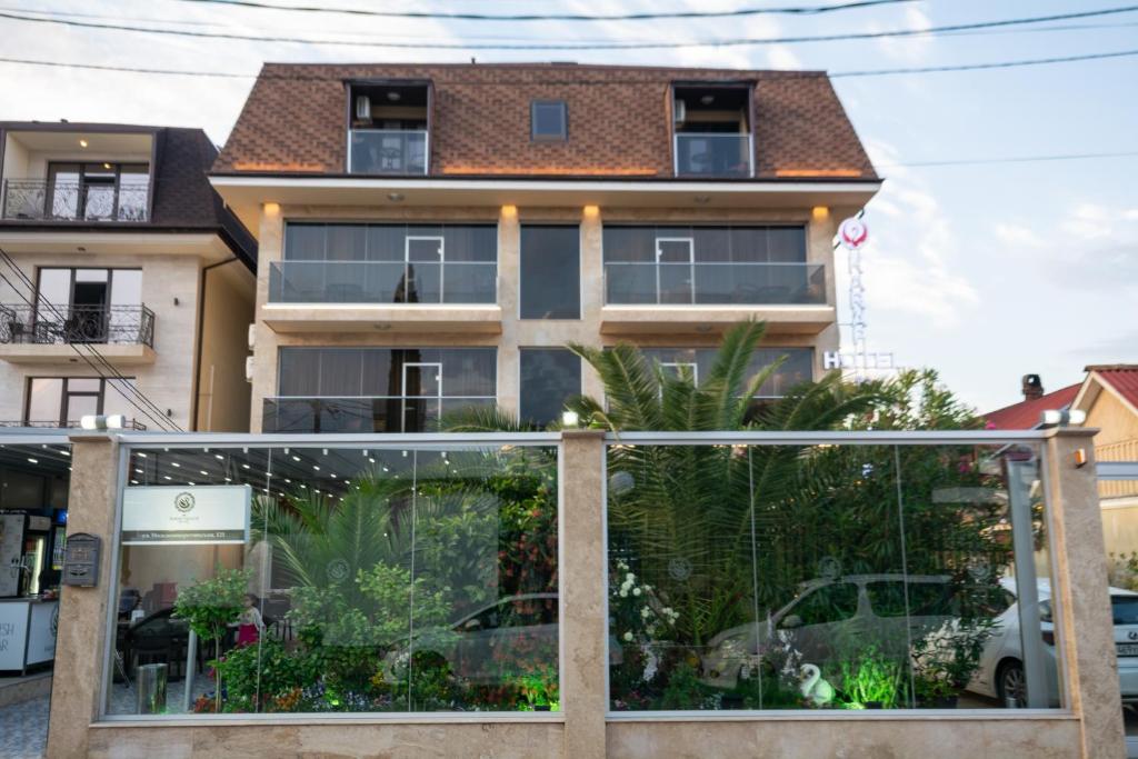 a house with a glass gate in front of it at Karap Hotel in Adler