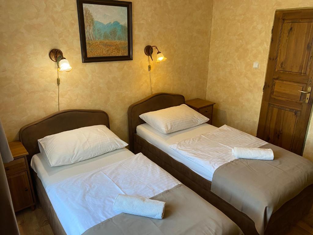 Postel nebo postele na pokoji v ubytování Penzión pri Kaštieli