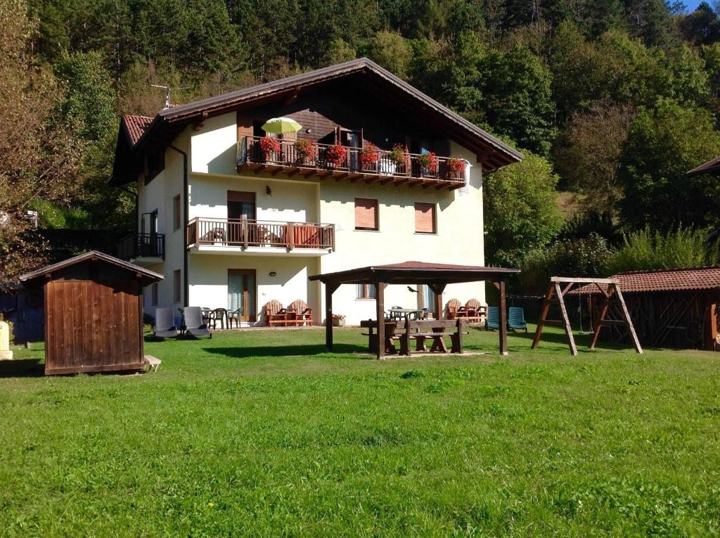 a large white house with a balcony on top of it at Casa Teresa in Ledro