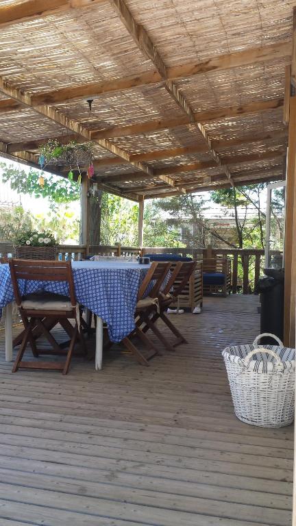 a patio with a table and chairs on a deck at Mobilhome Pampelonne Jacobs in Saint-Tropez