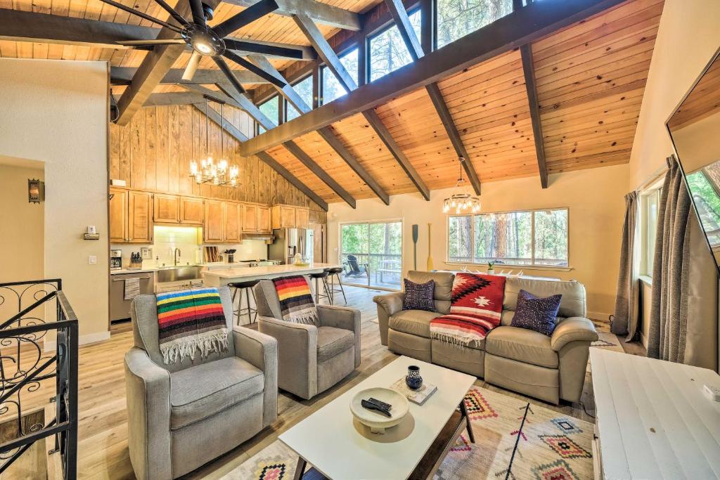 a living room with couches and a kitchen at Pine Mountain Cabin with Hot Tub, 2 Mins to Marina! in Groveland
