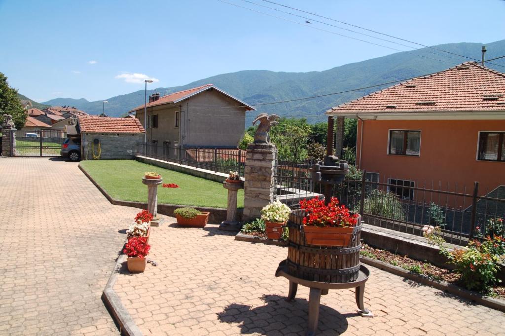 a house with a garden with flowers and a fountain at Il Poietto in Borgone Susa