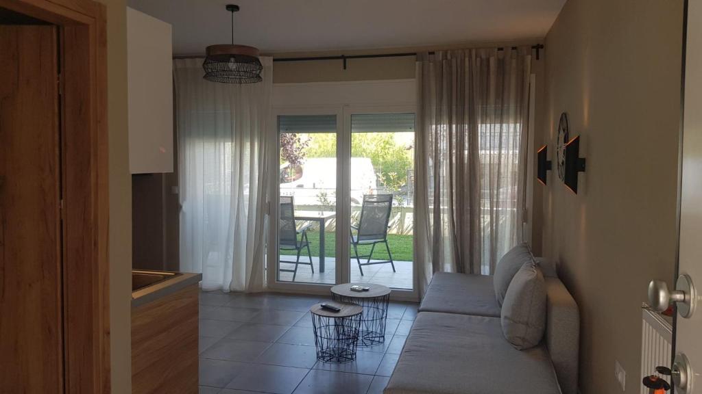 un salon avec un canapé et une table dans l'établissement Onar View Apartment, à Néa Péramos