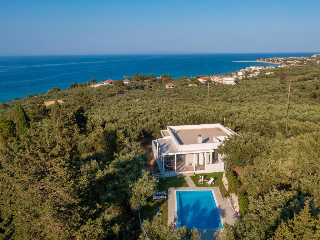 an aerial view of a house on a hill with a swimming pool at Ammoudi Harmony Villa in Amoudi