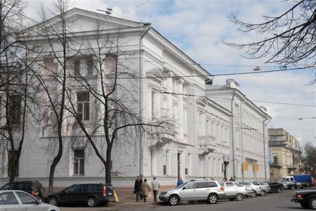 a large white building with cars parked in front of it at Guesthouse of the Pastukhov Academy in Yaroslavl