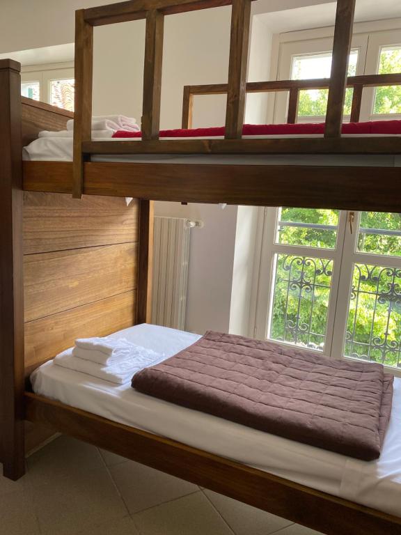 a bedroom with two bunk beds and a window at Ostello Voltaggio in Voltaggio