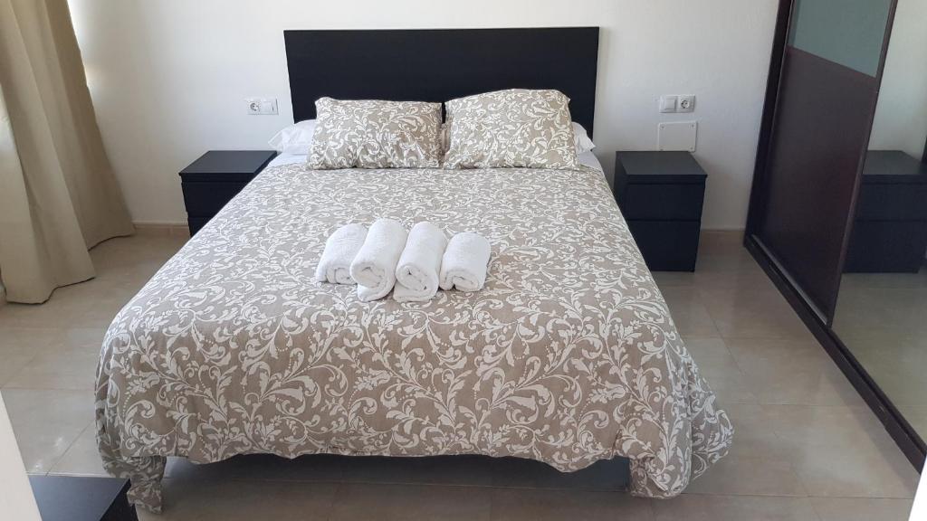 Кровать или кровати в номере Vivienda vacacional Arisa