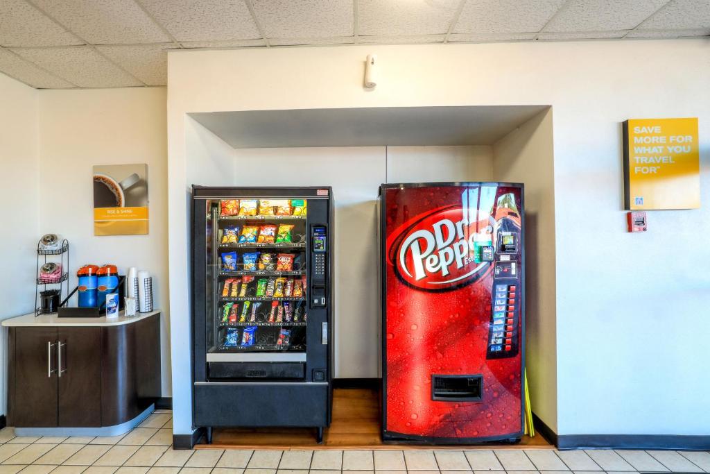 a coca cola machine next to a soda refrigerator at Motel 6-Longview, TX - North in Longview