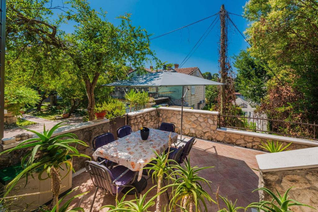 a patio with a table and chairs and a fence at Villa Lia in Dubrovnik