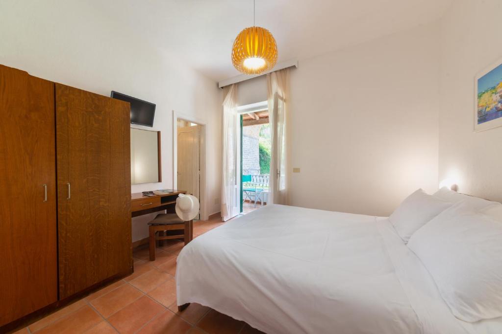 Postel nebo postele na pokoji v ubytování Villa Bina Sea Hotel