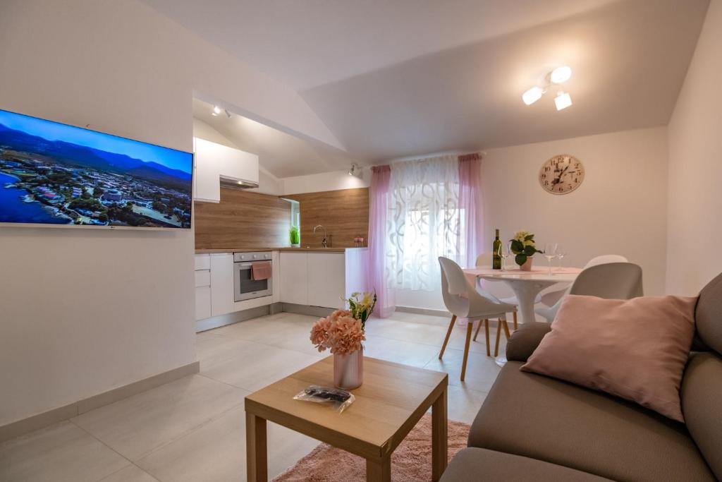 a living room with a couch and a table at Antique center Pula in Pula