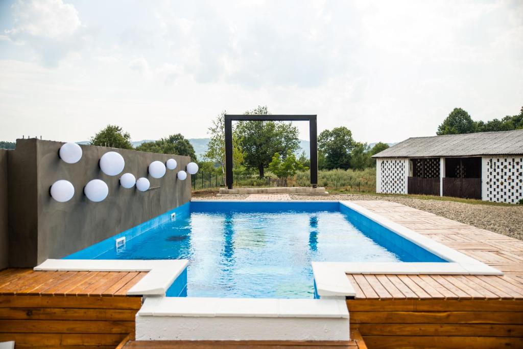 a swimming pool in the backyard of a house at Skriveni raj in Gornji Milanovac