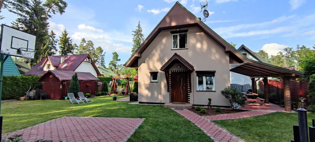 a house with a basketball hoop in the yard at Nad Miedwinką - Dom in Morzyczyn
