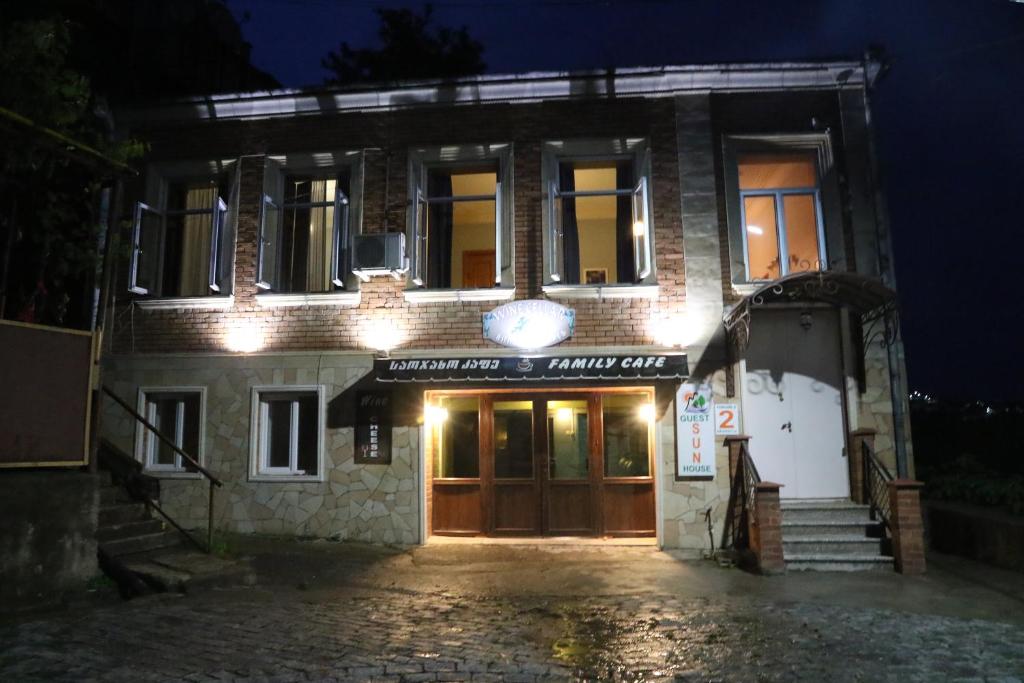 a building with lights on the front of it at night at Sun Guest House in Kutaisi